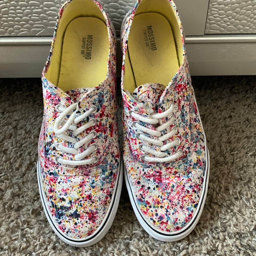 Splatter color shoes with white shoe laces.